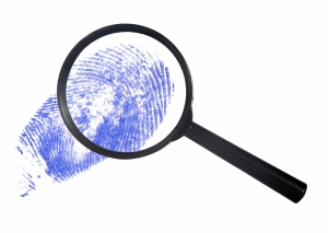 magnifying glass over a blue finger print